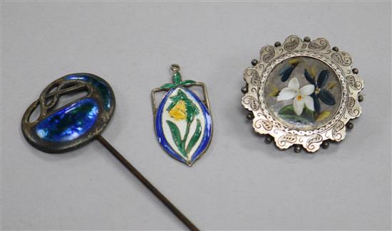 An early 20th century Art Nouveau silver and enamel hat pin, a silver and enamel pendant and a silver and enamel brooch.